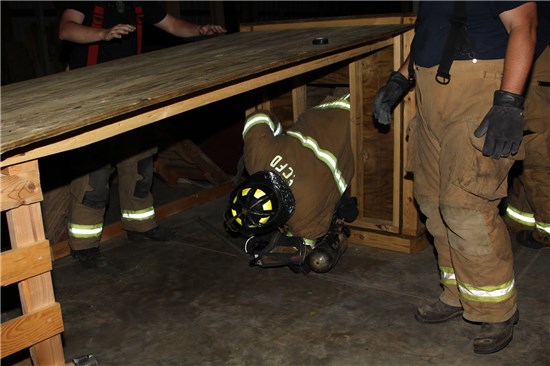 Firefighter Crawling out of Training Facility