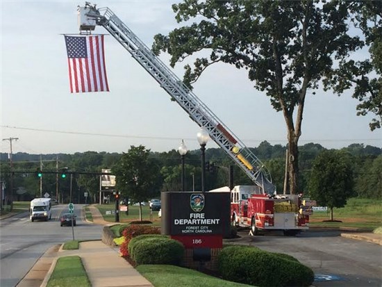 Ladder Truck Fully Extended with Hanging American Flag